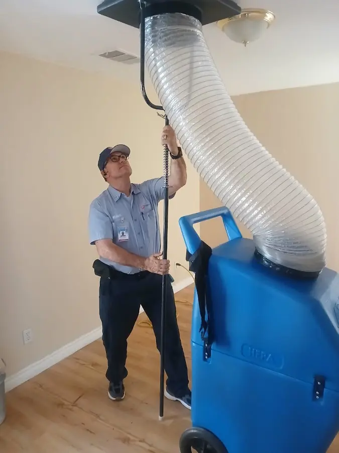 Furnace Tune-Up technician using HEPA equipment in League City